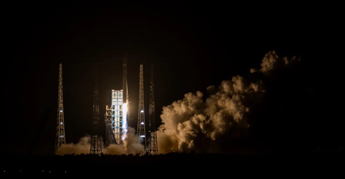 Nighttime launch of the Long March 12 rocket from the Wenchang Commercial Space Launch Site, illuminating the sky with bright flames and plumes of smoke